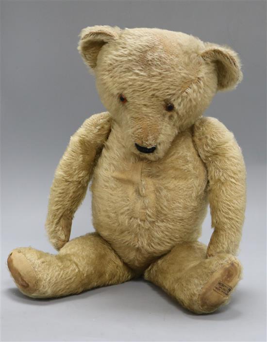 A 1930s Merrythought teddy bear, Theo, with pale blond mohair, deep amber and black glass eyes, pronounced